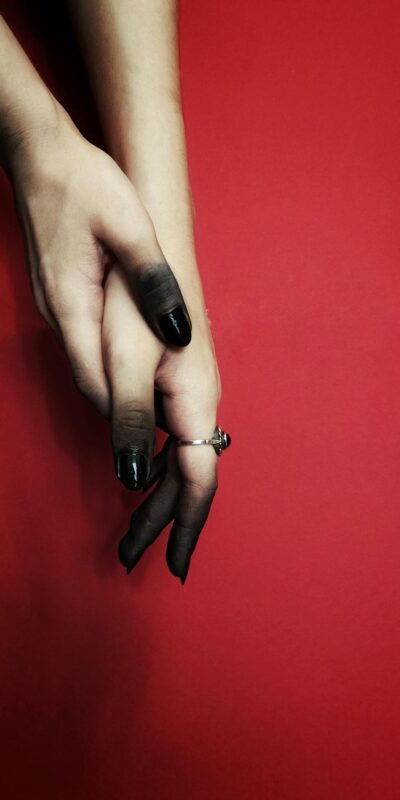 Hands in Black Tint against Red Background