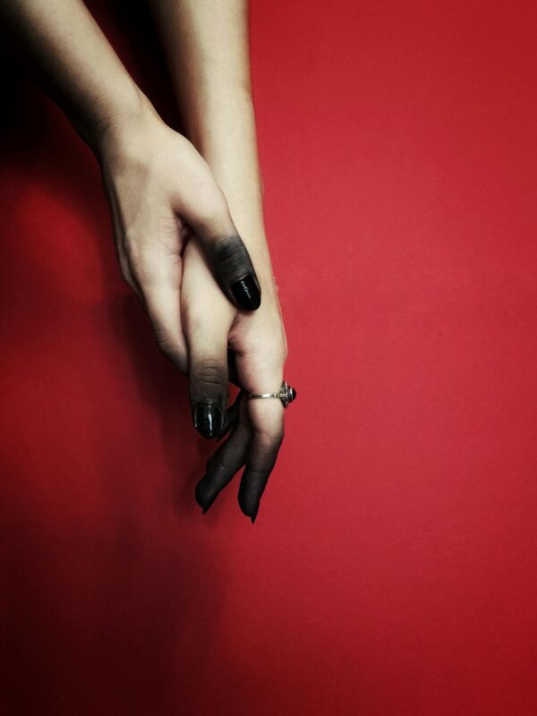 Hands in Black Tint against Red Background